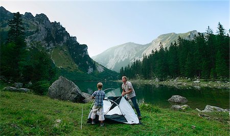 Father and son pitching tent together Stock Photo - Premium Royalty-Free, Code: 649-06622320