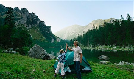 parents celebrating with child - Father and son pitching tent together Stock Photo - Premium Royalty-Free, Code: 649-06622321
