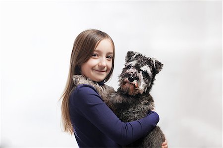 simsearch:649-06401393,k - Smiling girl holding dog Stock Photo - Premium Royalty-Free, Code: 649-06622360