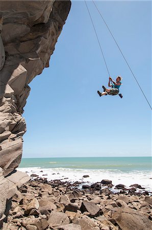 female outdoor sports - Rock climber abseiling jagged cliff Stock Photo - Premium Royalty-Free, Code: 649-06622375