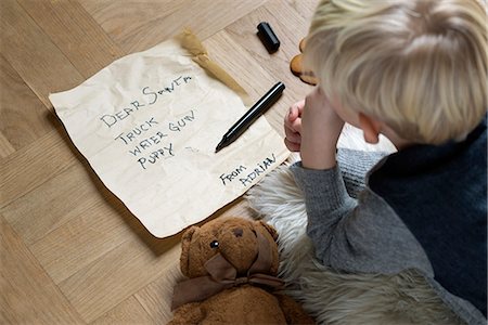 Boy writing Christmas list for Santa Stock Photo - Premium Royalty-Free, Code: 649-06622468