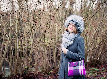 Smiling woman walking in forest Stock Photo - Premium Royalty-Free, Code: 649-06622604