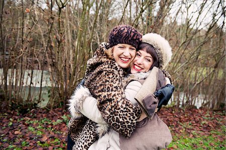 Smiling women hugging in forest Stock Photo - Premium Royalty-Free, Code: 649-06622610