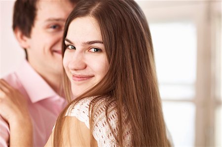 flirting - Smiling couple hugging indoors Stock Photo - Premium Royalty-Free, Code: 649-06622695