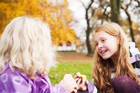 pre teen girl eating - Girls eating together outdoors Stock Photo - Premium Royalty-Free, Code: 649-06623069