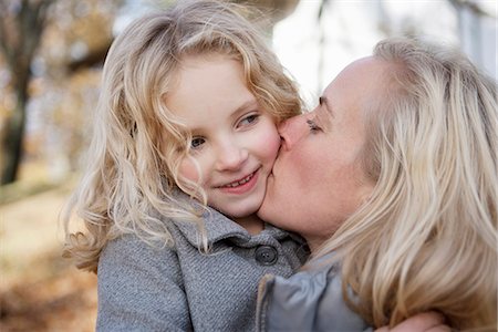 daughter kissing mother - Mother kissing daughter outdoors Stock Photo - Premium Royalty-Free, Code: 649-06623082