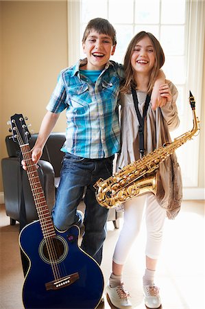sister brother hugging two - Children holding musical instruments Stock Photo - Premium Royalty-Free, Code: 649-06716498