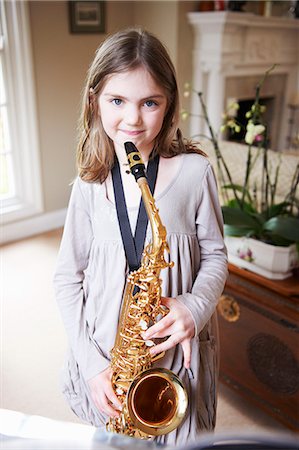 simsearch:649-06716505,k - Smiling girl playing saxophone Stock Photo - Premium Royalty-Free, Code: 649-06716500