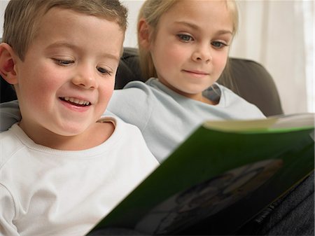 simsearch:649-06716505,k - Children reading together on sofa Stock Photo - Premium Royalty-Free, Code: 649-06716546