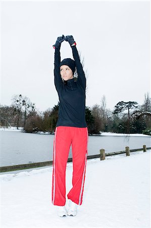 simsearch:649-06532763,k - Runner stretching in snowy field Photographie de stock - Premium Libres de Droits, Code: 649-06716637