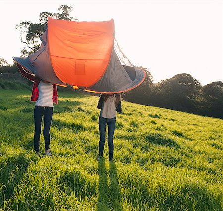 friend funny - Teenage girls pitching tent in field Stock Photo - Premium Royalty-Free, Code: 649-06716859