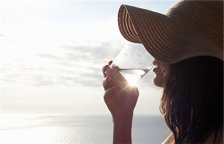 sunflare nature - Woman drinking glass of water outdoors Stock Photo - Premium Royalty-Free, Code: 649-06716882