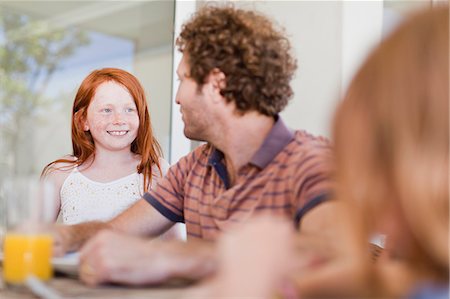 simsearch:649-05656972,k - Girl smiling at father at breakfast Stock Photo - Premium Royalty-Free, Code: 649-06716968