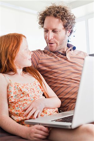 Father and daughter using laptop Stock Photo - Premium Royalty-Free, Code: 649-06716976