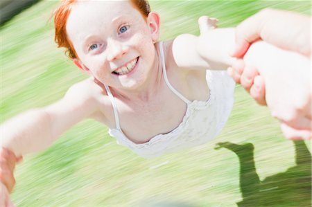 playing by the swing - Parent swinging daughter in grass Stock Photo - Premium Royalty-Free, Code: 649-06716992