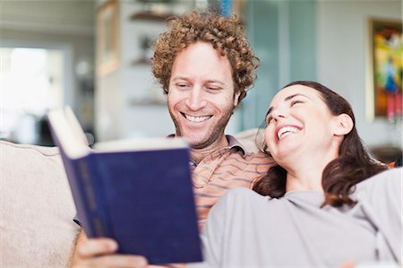 Couple reading together on sofa Stock Photo - Premium Royalty-Free, Code: 649-06717024