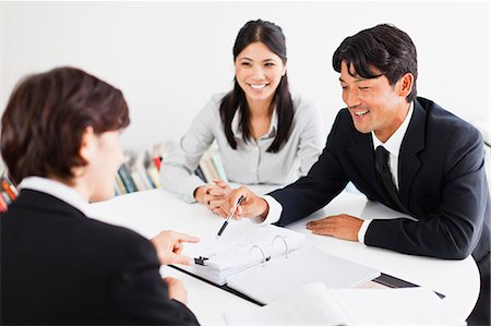 simsearch:649-06000952,k - Business people talking at desk Stock Photo - Premium Royalty-Free, Code: 649-06717064