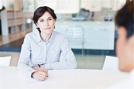 simsearch:649-06000952,k - Business people talking at desk Stock Photo - Premium Royalty-Free, Code: 649-06717074