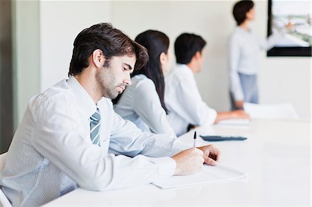 simsearch:649-06000952,k - Businessman taking notes in meeting Stock Photo - Premium Royalty-Free, Code: 649-06717076