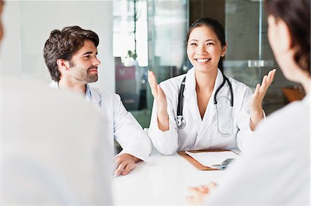 simsearch:649-06716741,k - Doctor talking to colleagues in meeting Stock Photo - Premium Royalty-Free, Code: 649-06717110