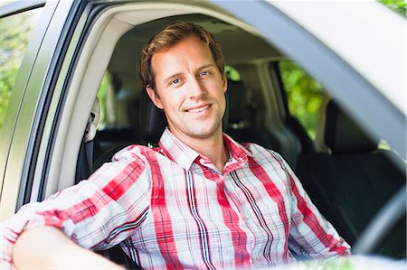 driving (vehicle) - Smiling man sitting in car Stock Photo - Premium Royalty-Free, Code: 649-06717275