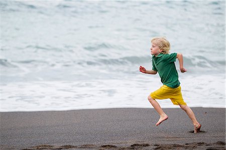 Boy running on beach Stock Photo - Premium Royalty-Free, Code: 649-06717313