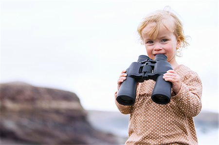 exploring children - Toddler girl using binoculars on beach Stock Photo - Premium Royalty-Free, Code: 649-06717320