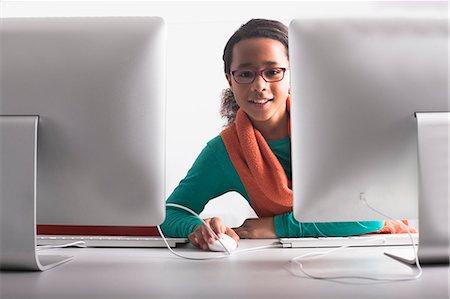 Woman using computer at desk Stock Photo - Premium Royalty-Free, Code: 649-06717366