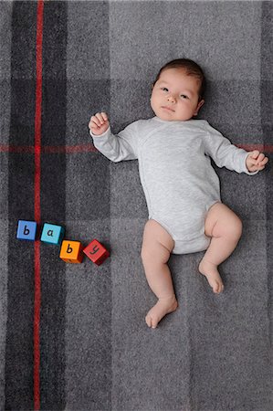 Baby boy laying on bed Stock Photo - Premium Royalty-Free, Code: 649-06717444