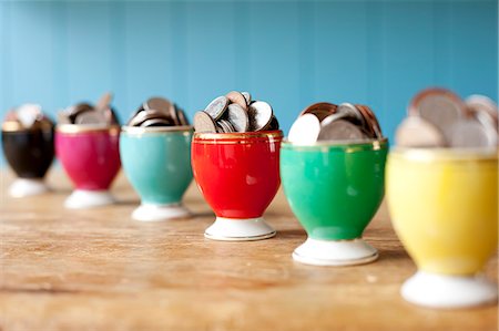 saving - Egg cups full of money on desk Stock Photo - Premium Royalty-Free, Code: 649-06717484