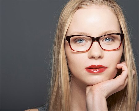 female on gray background - Close up of womans serious face Stock Photo - Premium Royalty-Free, Code: 649-06717544