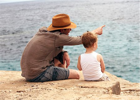 dad not mom child back - Father and son overlooking ocean Stock Photo - Premium Royalty-Free, Code: 649-06717803