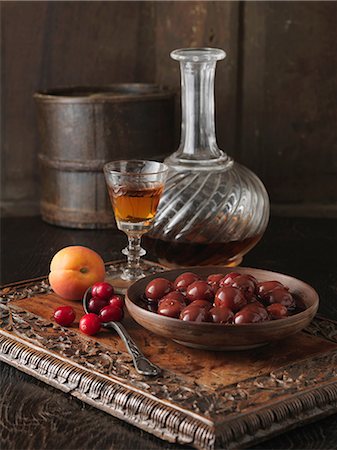 Ingredients for cranberry and Morello cherry stuffing. Cranberries, Morello cherries, apricots and brandy on carved wooden board Stock Photo - Premium Royalty-Free, Code: 649-06812318