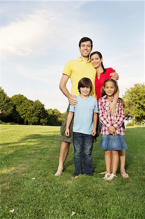 family in park - Portrait of family with two children standing on grass Stock Photo - Premium Royalty-Free, Code: 649-06812450