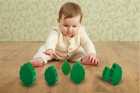 Baby girl with toy trees Stock Photo - Premium Royalty-Free, Code: 649-06812530