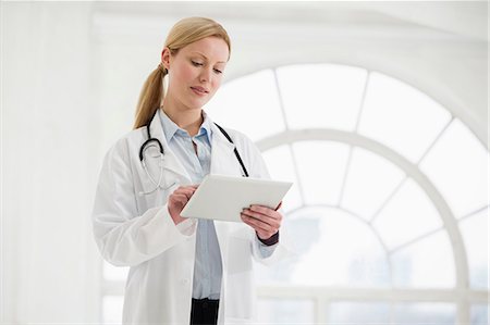 Portrait of female doctor with stethoscope and digital tablet Stock Photo - Premium Royalty-Free, Code: 649-06812569