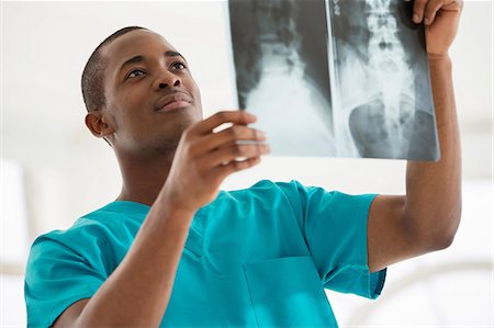 Young man examining xray Stock Photo - Premium Royalty-Free, Code: 649-06812578