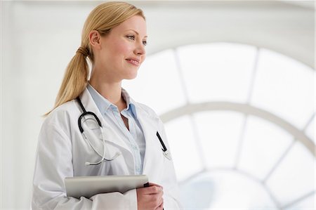 Portrait of female doctor with stethoscope and digital tablet Stock Photo - Premium Royalty-Free, Code: 649-06812570
