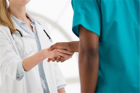 Two doctors shaking hands, mid section Stock Photo - Premium Royalty-Free, Code: 649-06812586