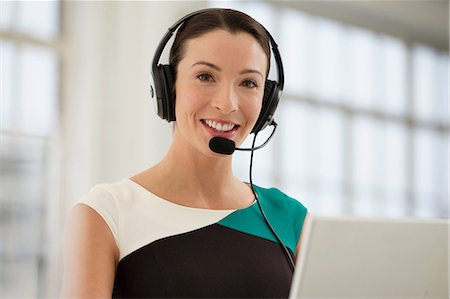 Female telephonist wearing headset Stock Photo - Premium Royalty-Free, Code: 649-06812601