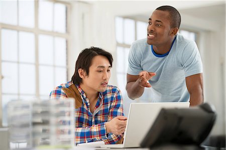 Two male colleagues using laptop Stock Photo - Premium Royalty-Free, Code: 649-06812603