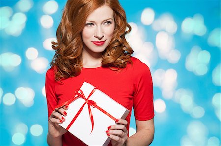 red interiors - Woman holding white gift box with red bow Stock Photo - Premium Royalty-Free, Code: 649-06812638