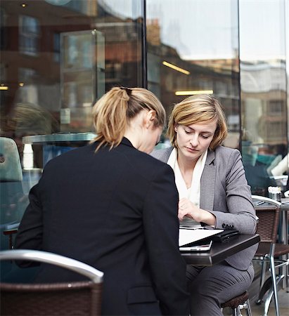 Two businesswomen meeting at outdoor cafe Stock Photo - Premium Royalty-Free, Code: 649-06812884