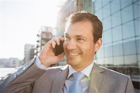simsearch:649-07520071,k - Mature businessman on cellphone in city Stock Photo - Premium Royalty-Free, Code: 649-06829638