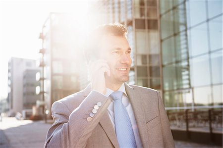Mature businessman on cellphone in city Stock Photo - Premium Royalty-Free, Code: 649-06829639