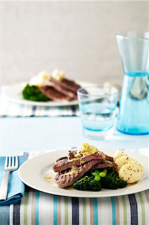 set table - Steak, potatoes, broccoli and dressing Stock Photo - Premium Royalty-Free, Code: 649-06830055