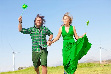 Young couple with pinwheels in filed Stock Photo - Premium Royalty-Free, Code: 649-06830091