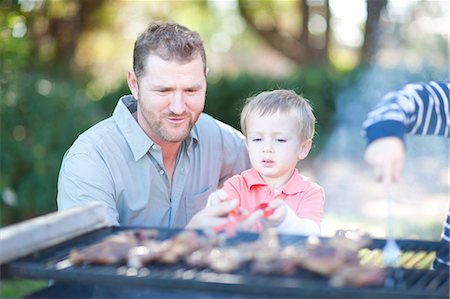 summer family backyard - Father and sons barbecuing Stock Photo - Premium Royalty-Free, Code: 649-06844127