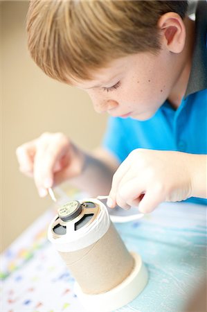experimenting - Boy making craft object Stock Photo - Premium Royalty-Free, Code: 649-06844285