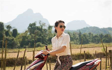 Woman on moped, Vang Vieng, Laos Stock Photo - Premium Royalty-Free, Code: 649-06844477